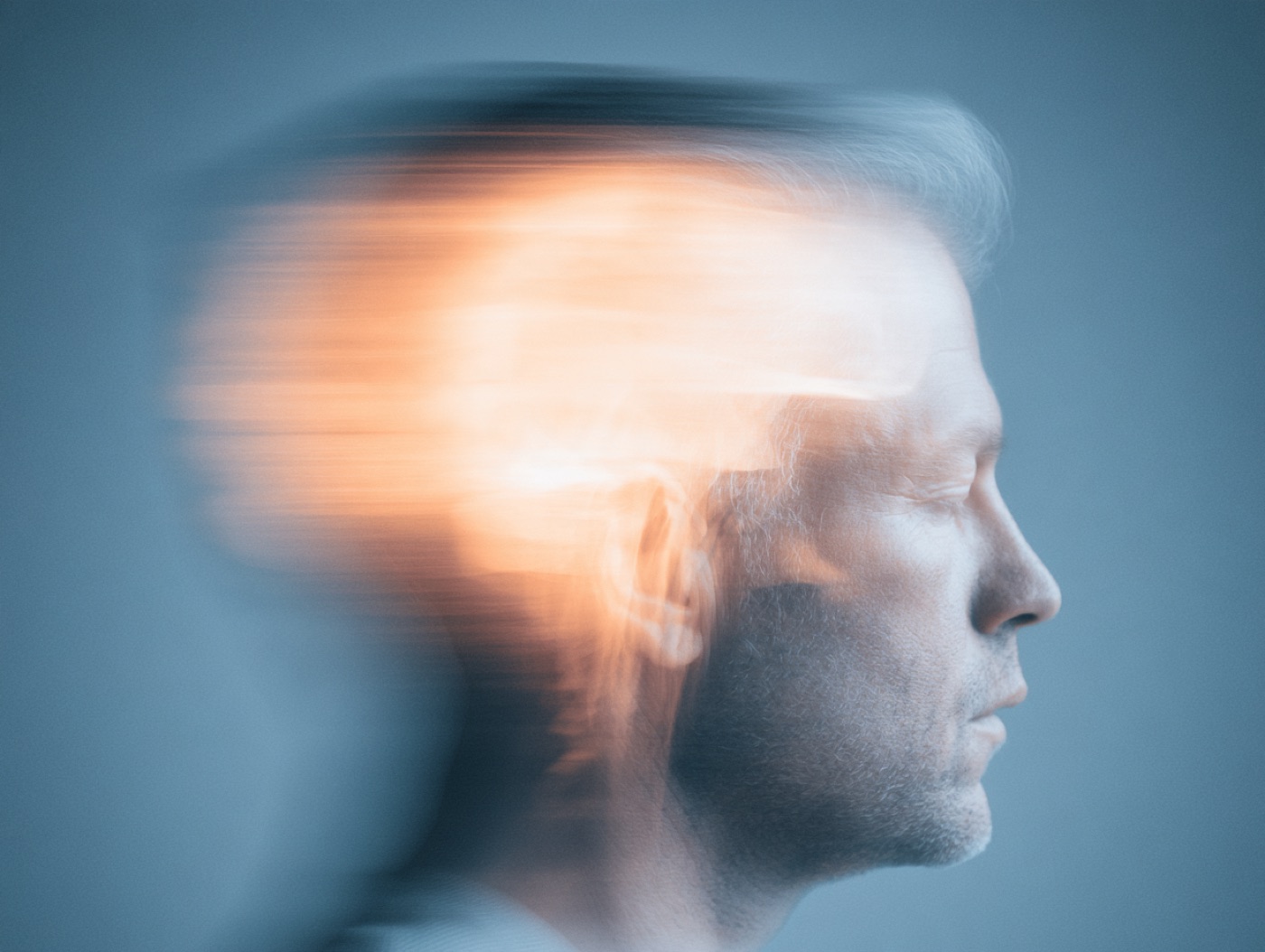 A leader in profile, a warm light moving through the head